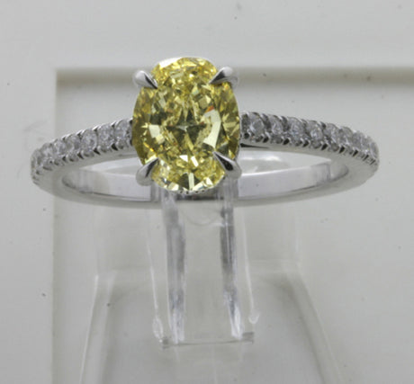 A ring with an intense yellow oval diamond