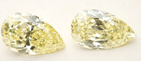 Two yellow pear shape diamonds